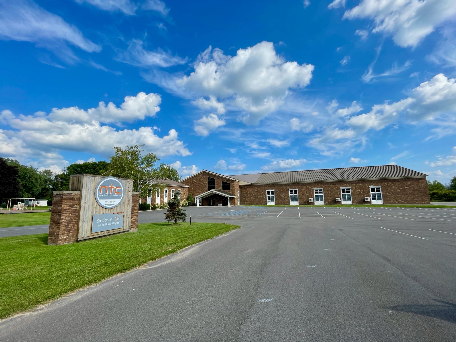 New Testament Church campus and sign in Massena
